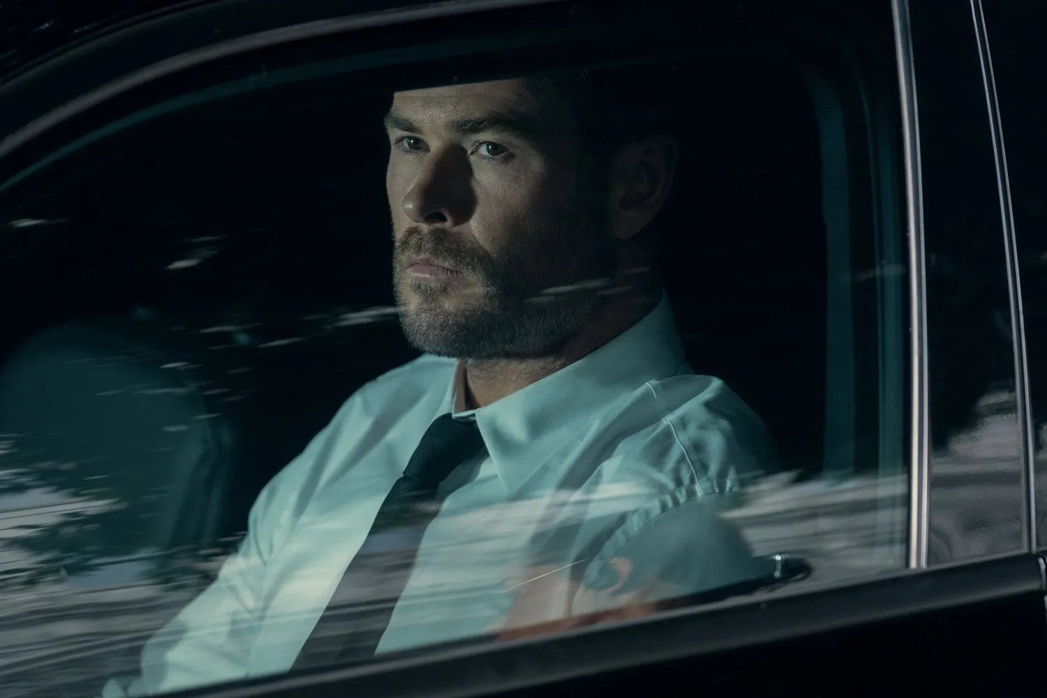 Chris Hemsworth sitting in a car.