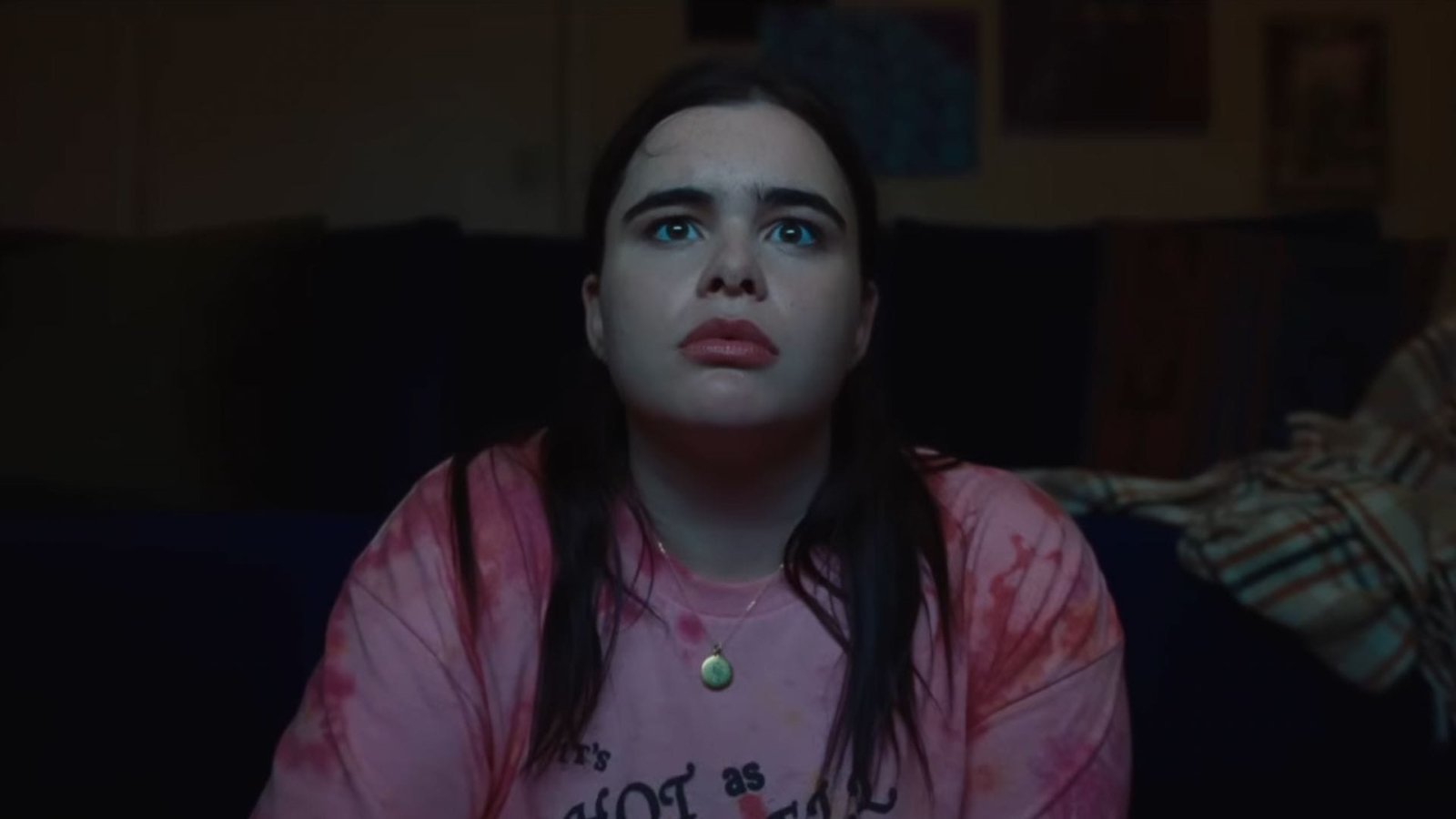Barbie Ferrera facing the camera, watching a video.